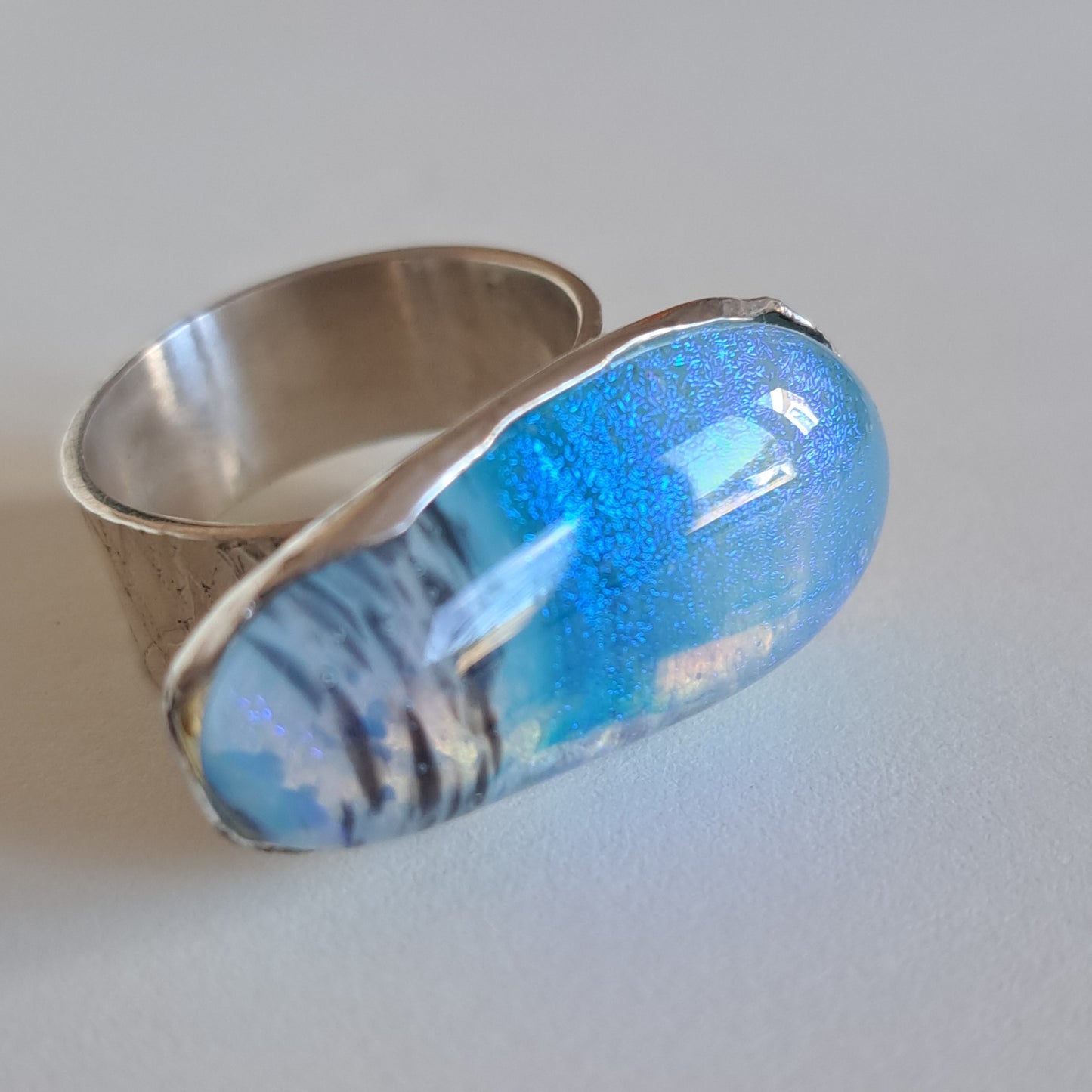 Pale blue and black dichroic fused glass and silver ring