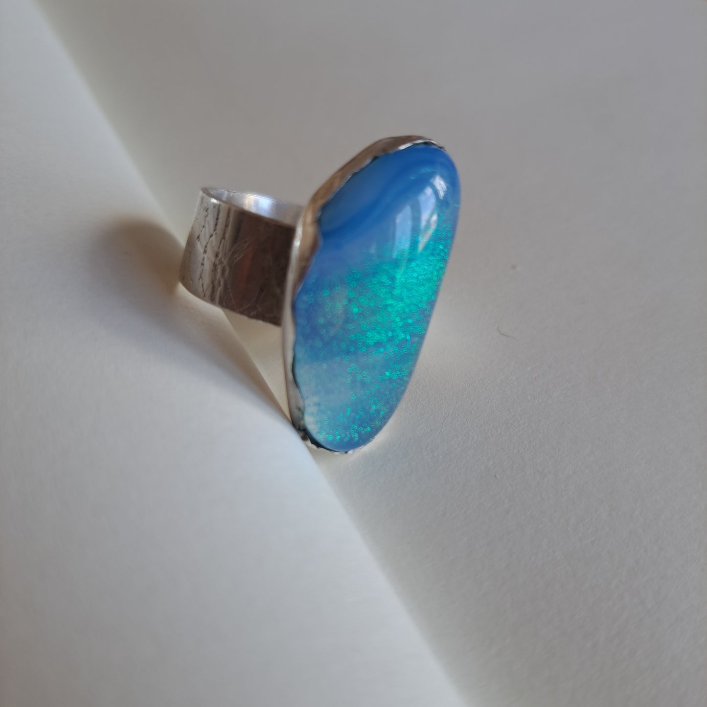 Pale blue dichroic glass and silver ring