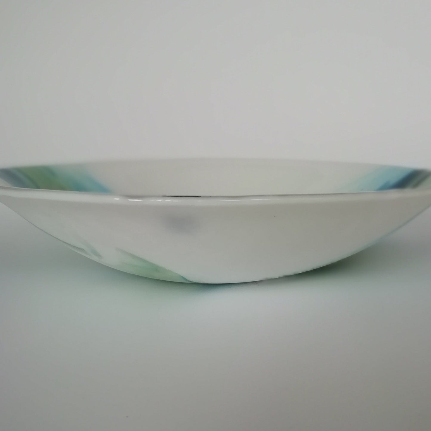 Green and white glass bowl